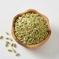 Whole fennel seeds in a wooden bowl on white background