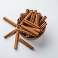 Whole cinnamon sticks in a wooden bowl on white background