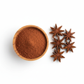 Star anise powder in a wooden bowl with whole star anise on white background