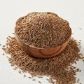 Whole cumin seeds in a wooden bowl on white background