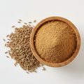 Cumin powder in a wooden bowl with whole cumin seeds on white background